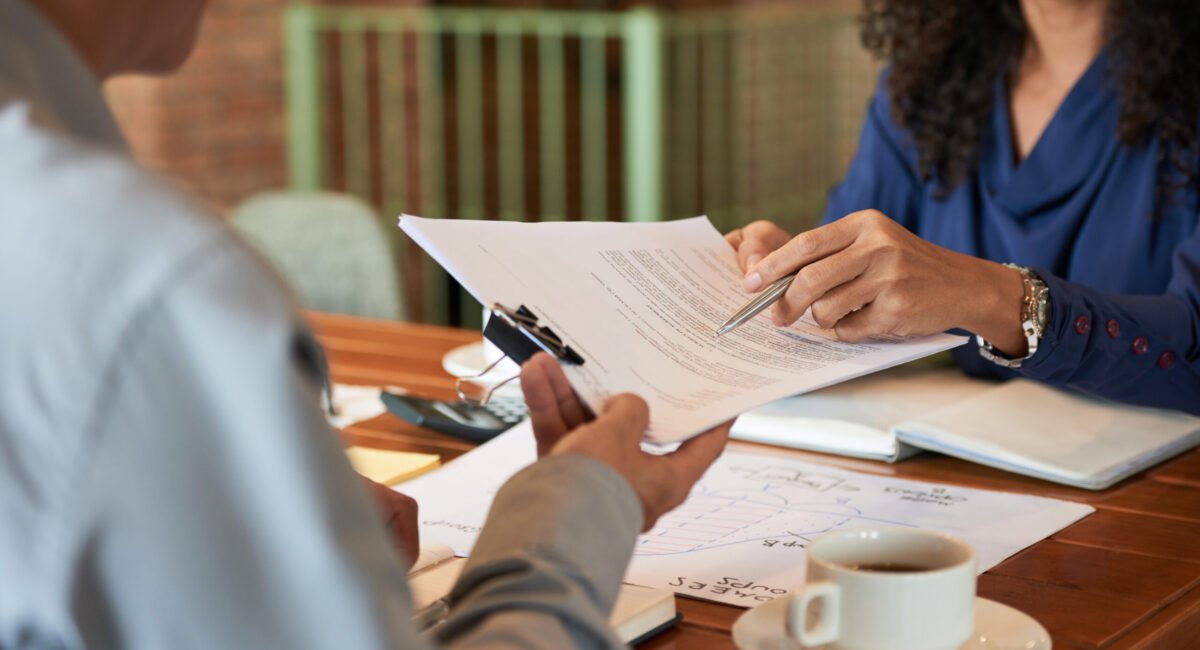 Businessman consulting with lawyer before signing contract