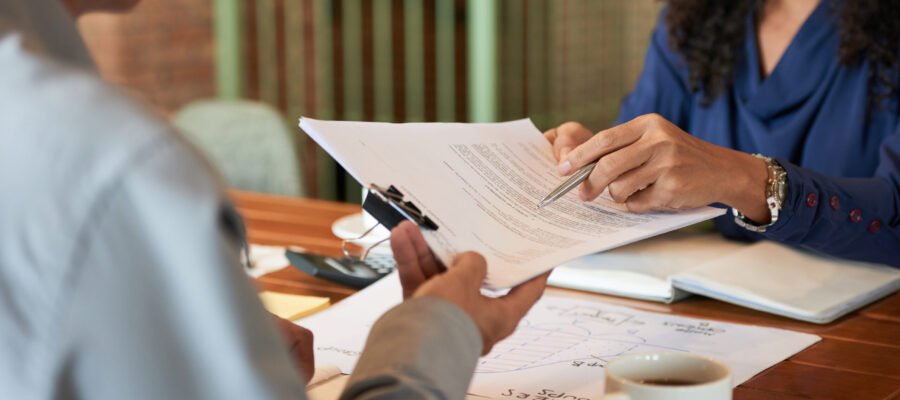 Businessman consulting with lawyer before signing contract